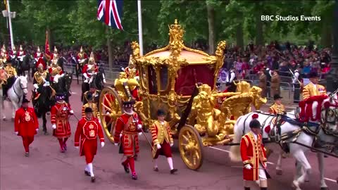 Old footage of Queen Elizabeth appears inside carriage