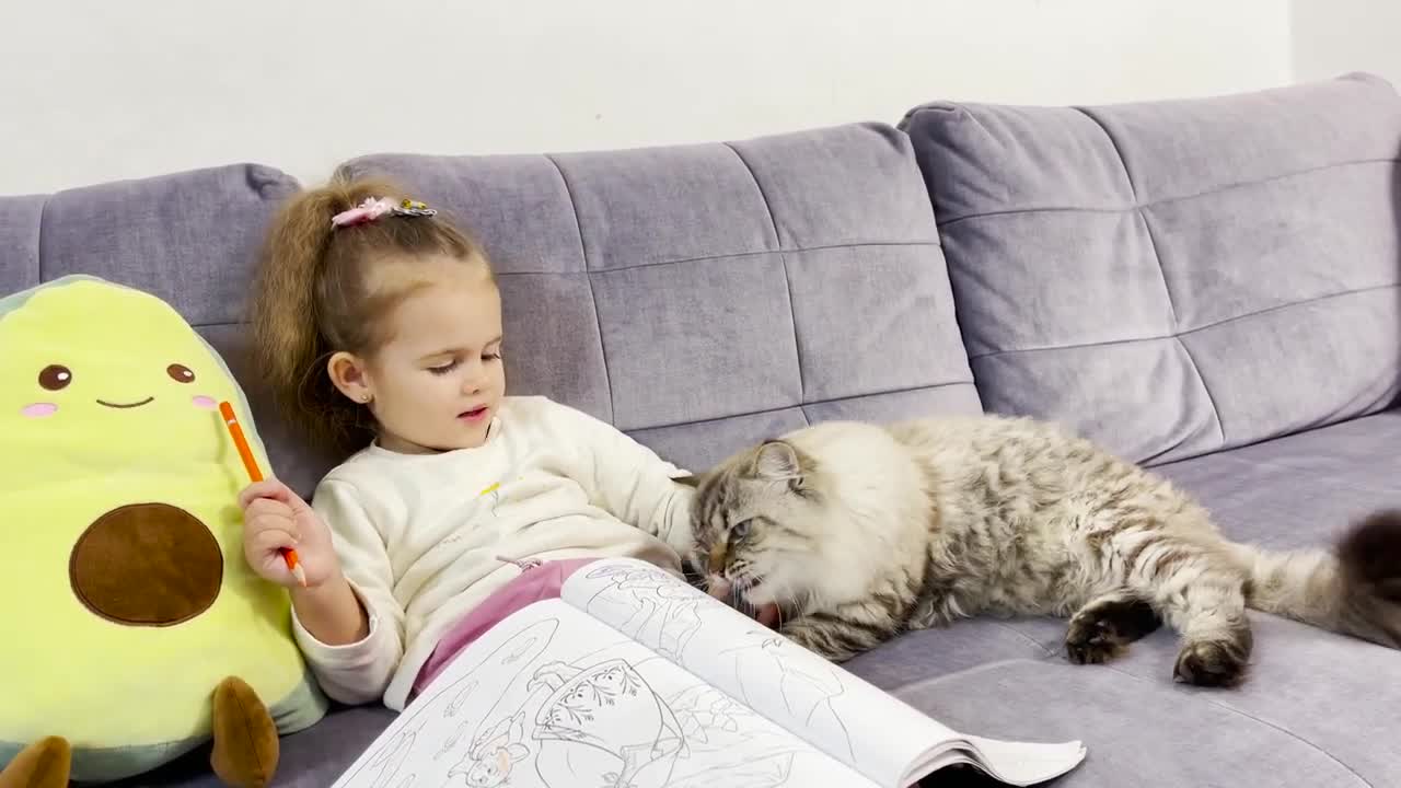 Cute Young Girl Teaches Drawing to Her Cat Theo