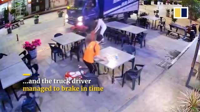 Chinese mother sprints to pull child away from oncoming truck