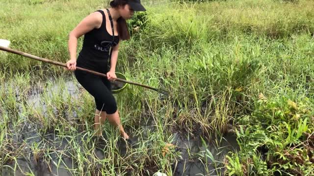 Beautiful girl looking for fish after storm