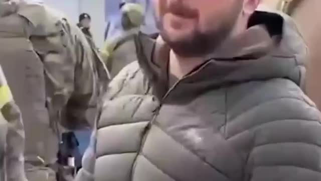 Woman raises a Russian flag right to Zelenskys face.