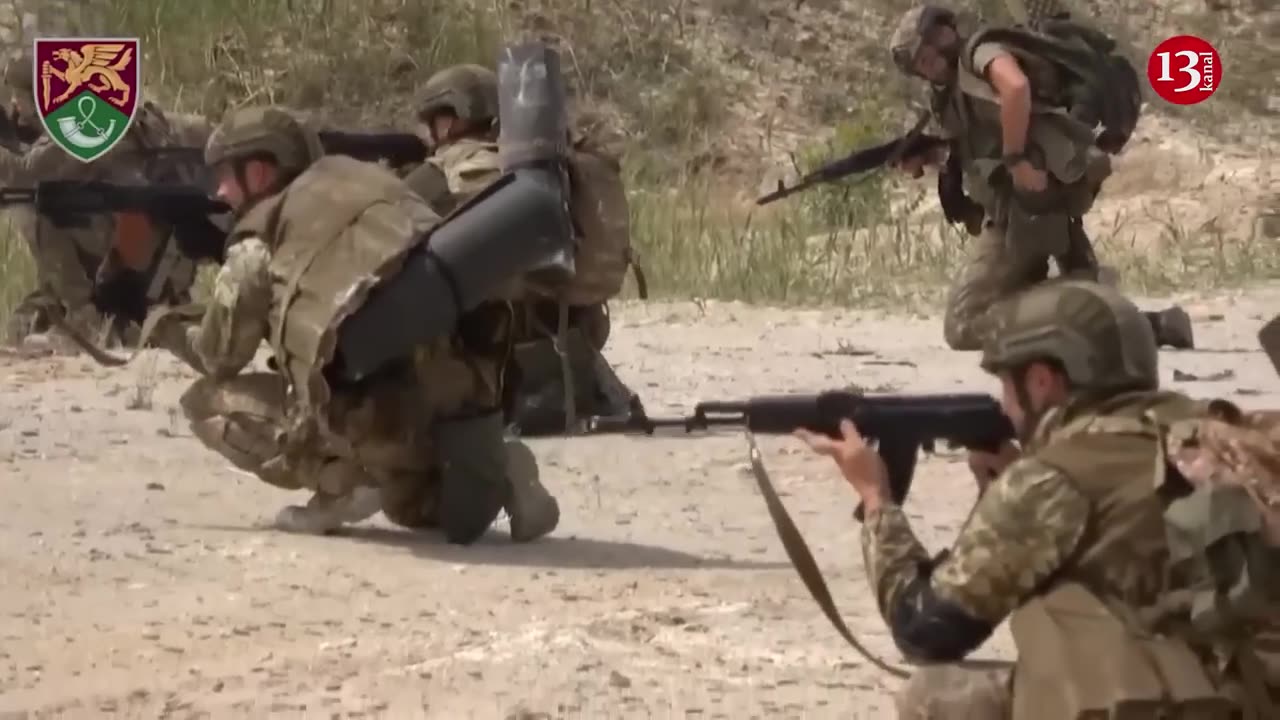 Fighters of Ukrainian amphibious assault brigade crossing river and preparing for a counter-attack