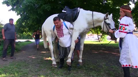 Strong Man Walks Carrying a Horse