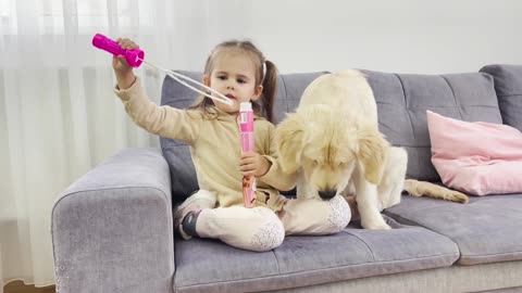 What Does Golden Retriever Puppy do When Little Girl Blows Bubbles