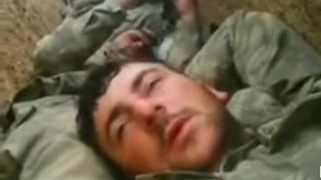 Exhausted Ukrainian soldiers resting in trench