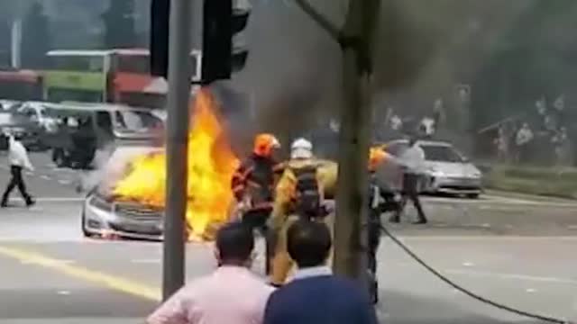 Burning Mercedes seen, at junction outside Lau Pa Sat