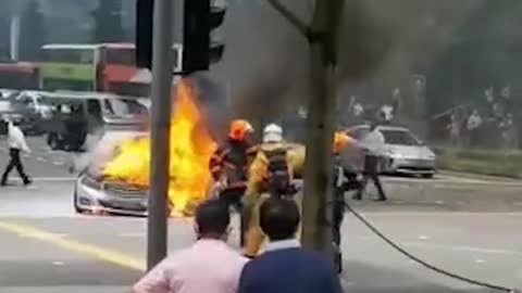 Burning Mercedes seen, at junction outside Lau Pa Sat