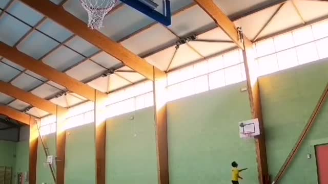 Man Performs Impressive Basketball Shots By Throwing Ball Through Multiple Hoops