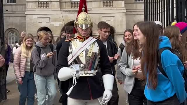 She tries to make the King’s Guard laugh