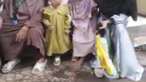 A group of mothers accompanies their children at school