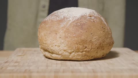 Tracking Shot of Loaf of Bread on Kitchen Workspace