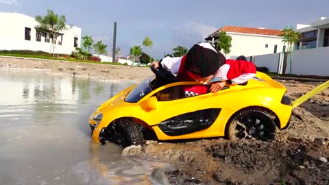 Nikita ride on children's car and stuck in a puddle