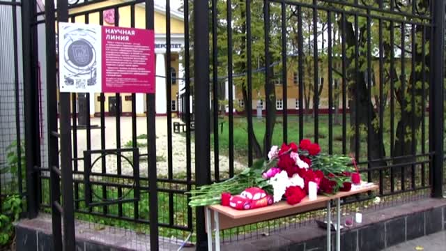 Russians lay flowers at scene of deadly shooting