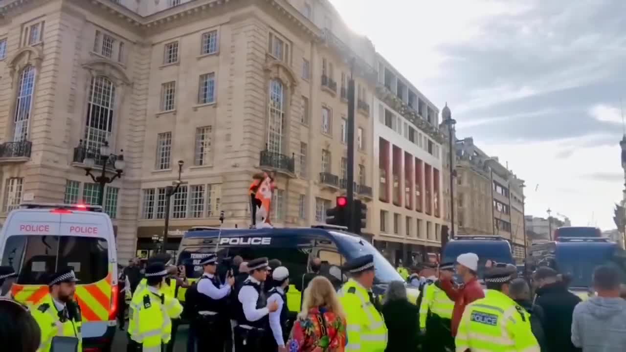 just stop oil supporter scales Metropolitan Police van, demands end to new oil a_2