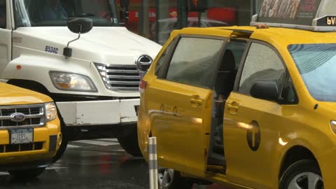 Lady Getting Into Taxi in Rain in New York