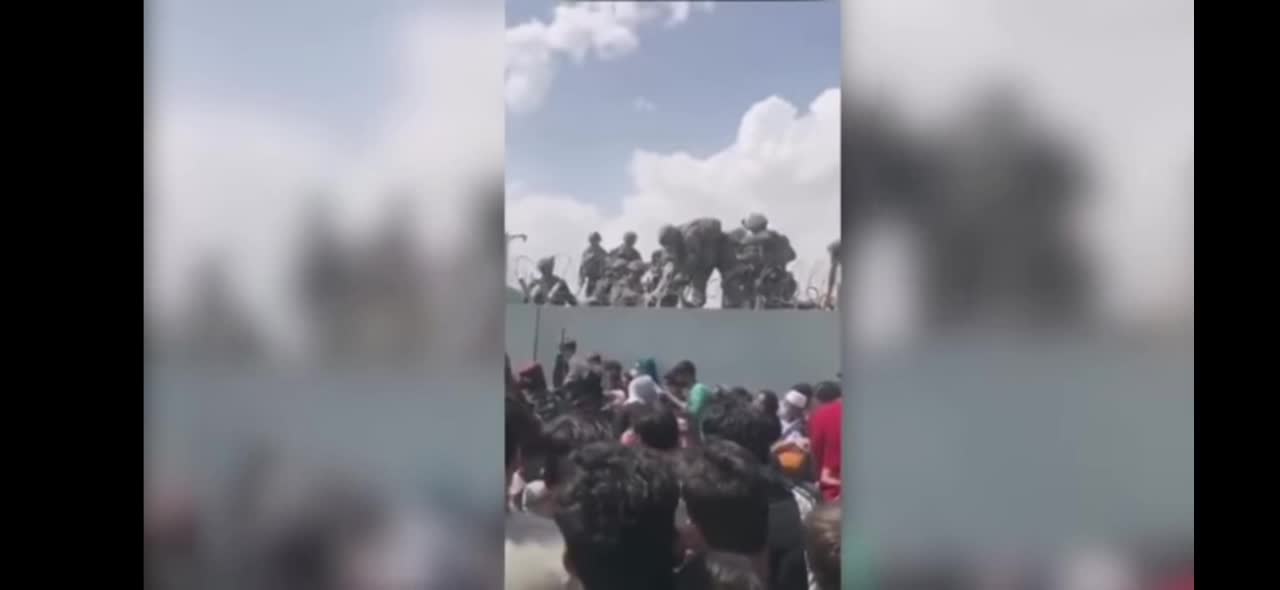 Afghan Mother Has Baby Handed Through Razor Wire