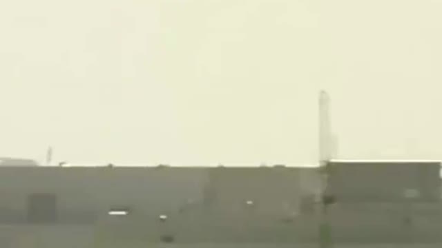 A U.S. Air Force transport helicopter evacuates people and property