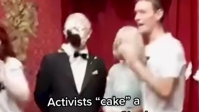 activists smashed cake into the face of a King Charles waxwork at Madame Tussauds in London