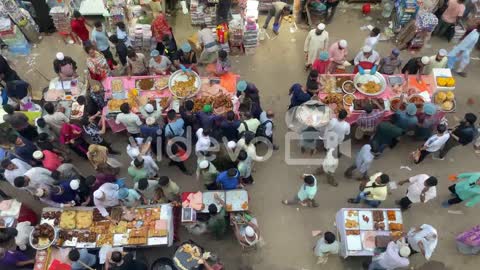 People buying food from a market in Bangladesh