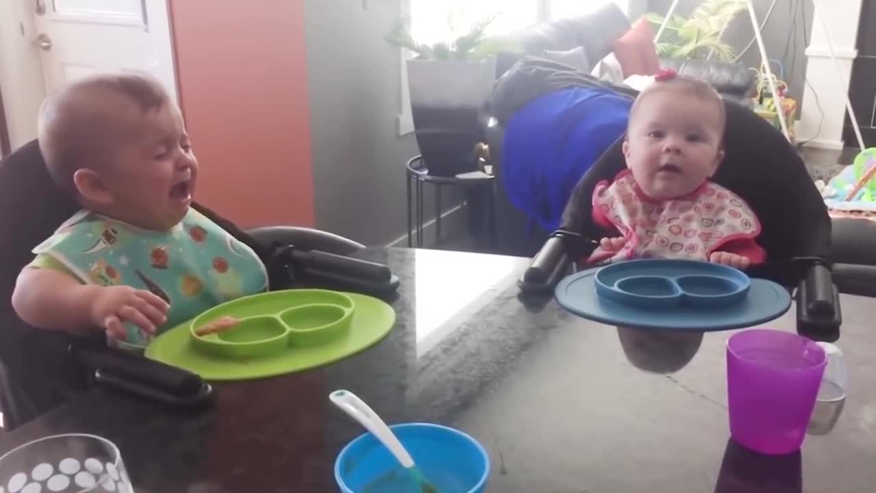 Adorable twin babies playing together