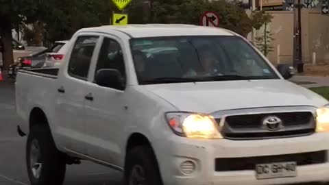 White helmet guy paddleboards down street