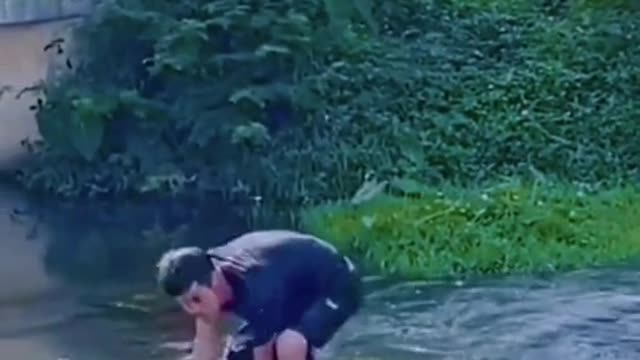 Car cross near by Man and throwing water on