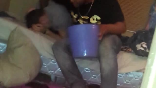 Guy grey shirt putting head in trash bin