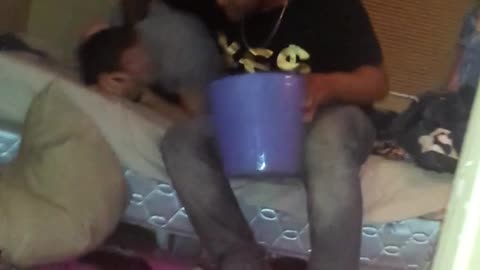Guy grey shirt putting head in trash bin