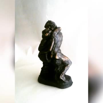 Handmade candle of a couple kissing.