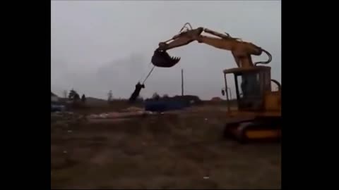 Guy having fun with a backhoe