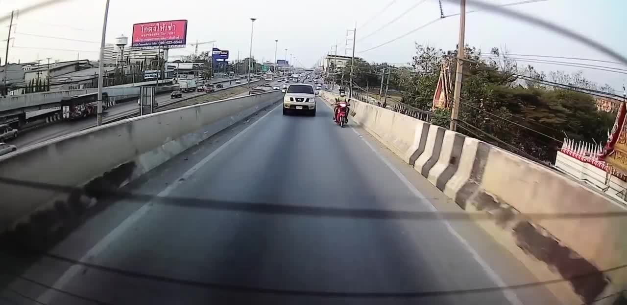 Moped with Two Passengers Goes for a Slide