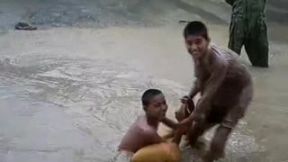 Boys enjoying street water in raining