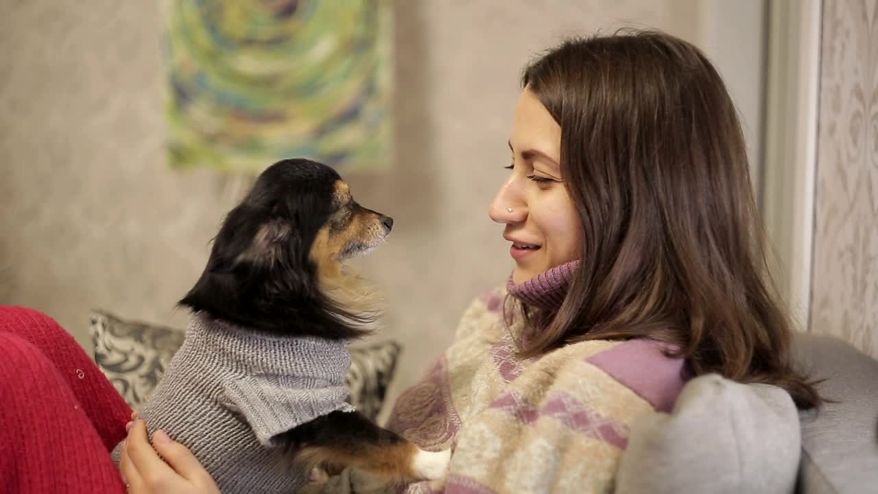 Young woman smiles at her pet