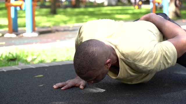 Shallow Focus of Man Doing One-Arm Push-Ups