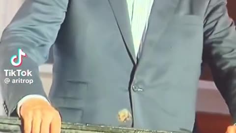 Biden dazed, with something stuck to his suit jacket?