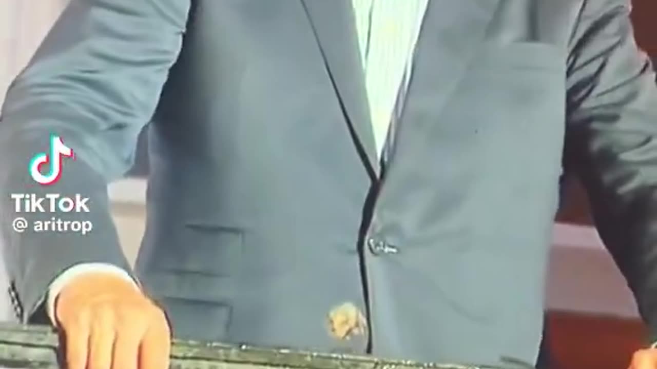 Biden dazed, with something stuck to his suit jacket?
