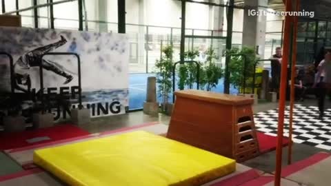 Black pants tries to flip over wooden horse falls on back