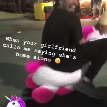 Guy in pink and white unicorn at fair