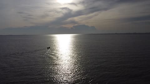 A lone fisherman sets off for his nightly catch into the empty ocean