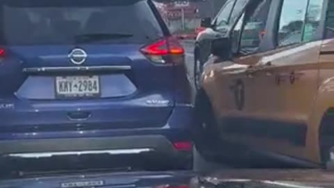 New York City taxi driver destroys an Israeli flag on another car while driving.