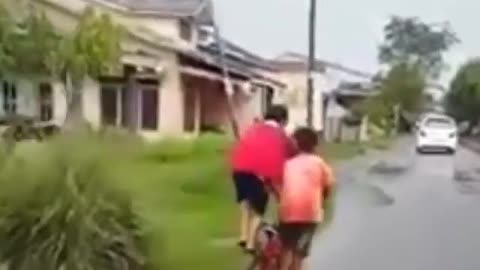 Two children ride bicycles with difficulty