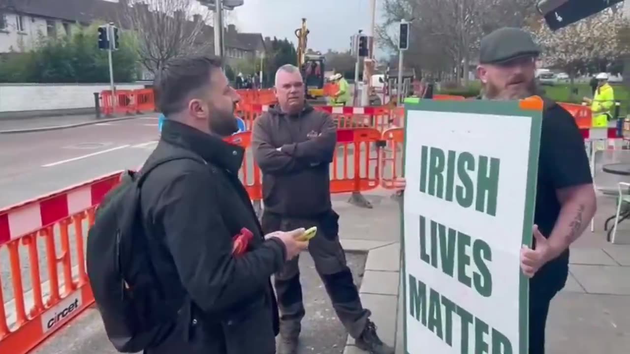 Irish patriot protests peacefully outside the headquarters of a company that