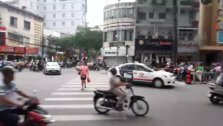 Lots of motorcycles ignoring pedestrians.