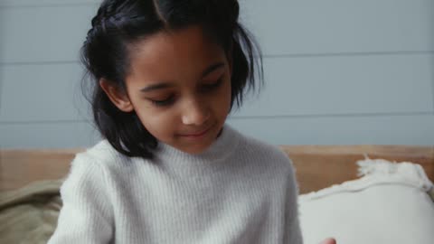 A Girl Petting Rabbits in the Bed