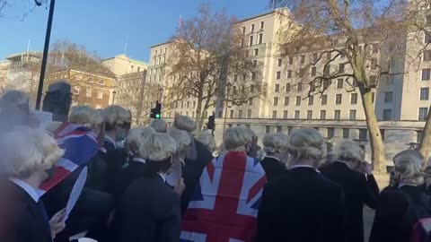 Crowd dressed like Boris Johnson party outside Downing Street. Chanting: