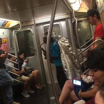 Guy blue shirt foil wings playing saxophone subway train man