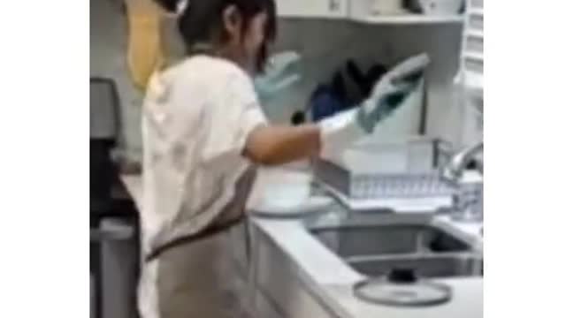 Girl danceing washing plate sink