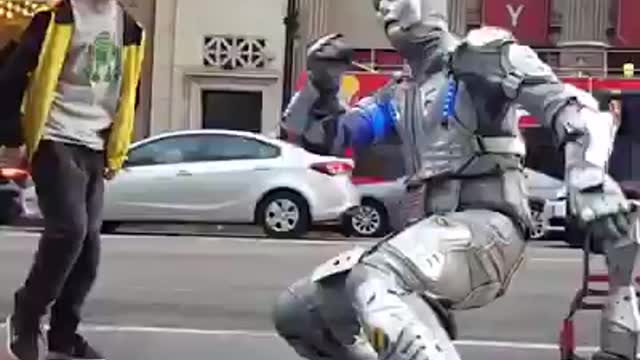 BOY DANCING WITH ROBO ON STREETS