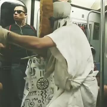 People in white costumes performing on subway