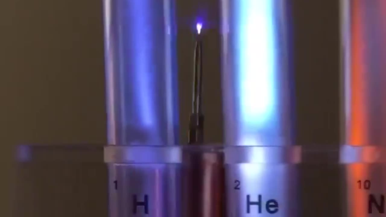 7 cylinders containing elementary gases, close to a working Tesla coil.